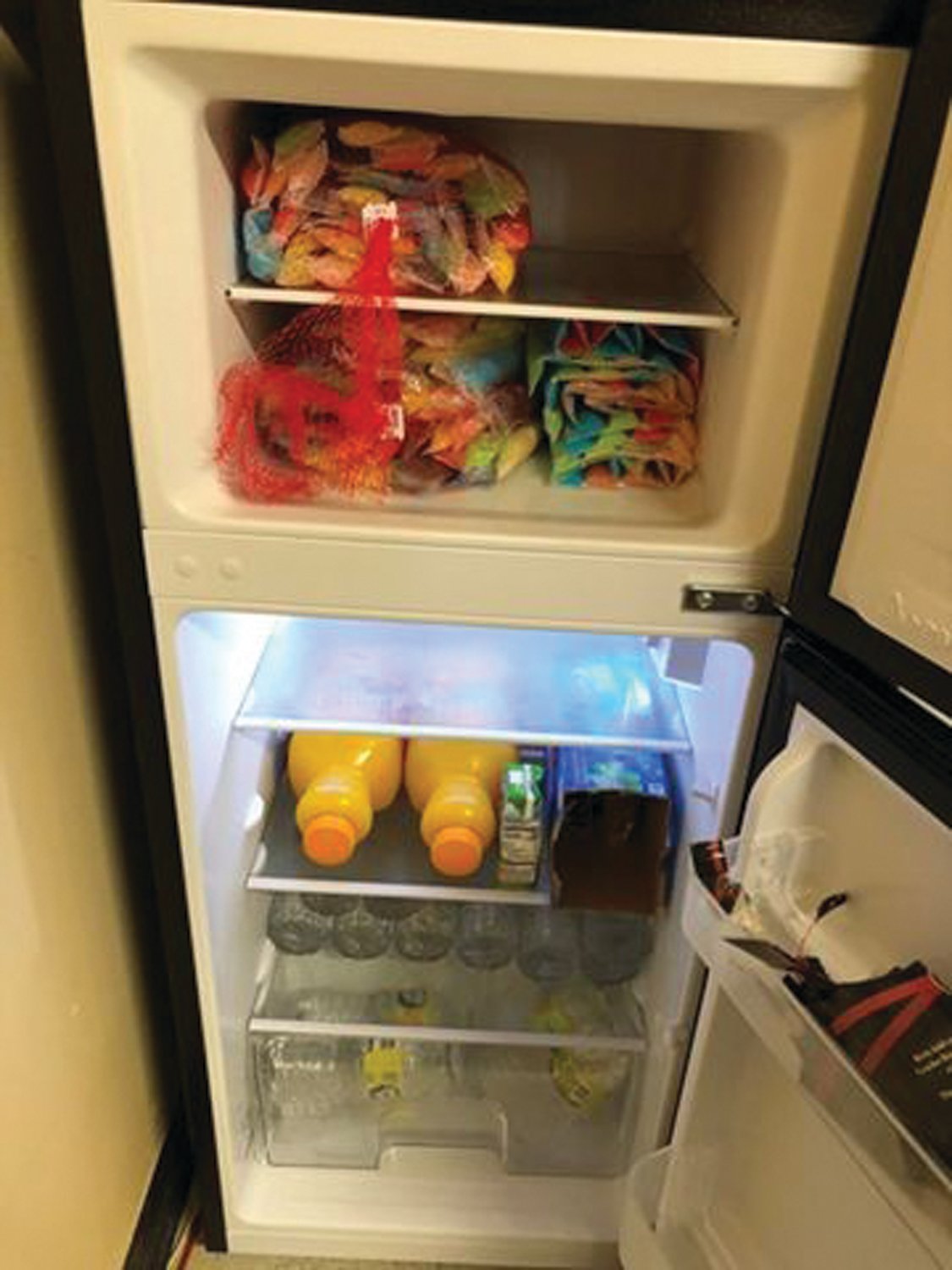 A new refrigerator in the BCHG community room, purchased with VIA Neighbors in Need funding, holds healthy snacks for the children.