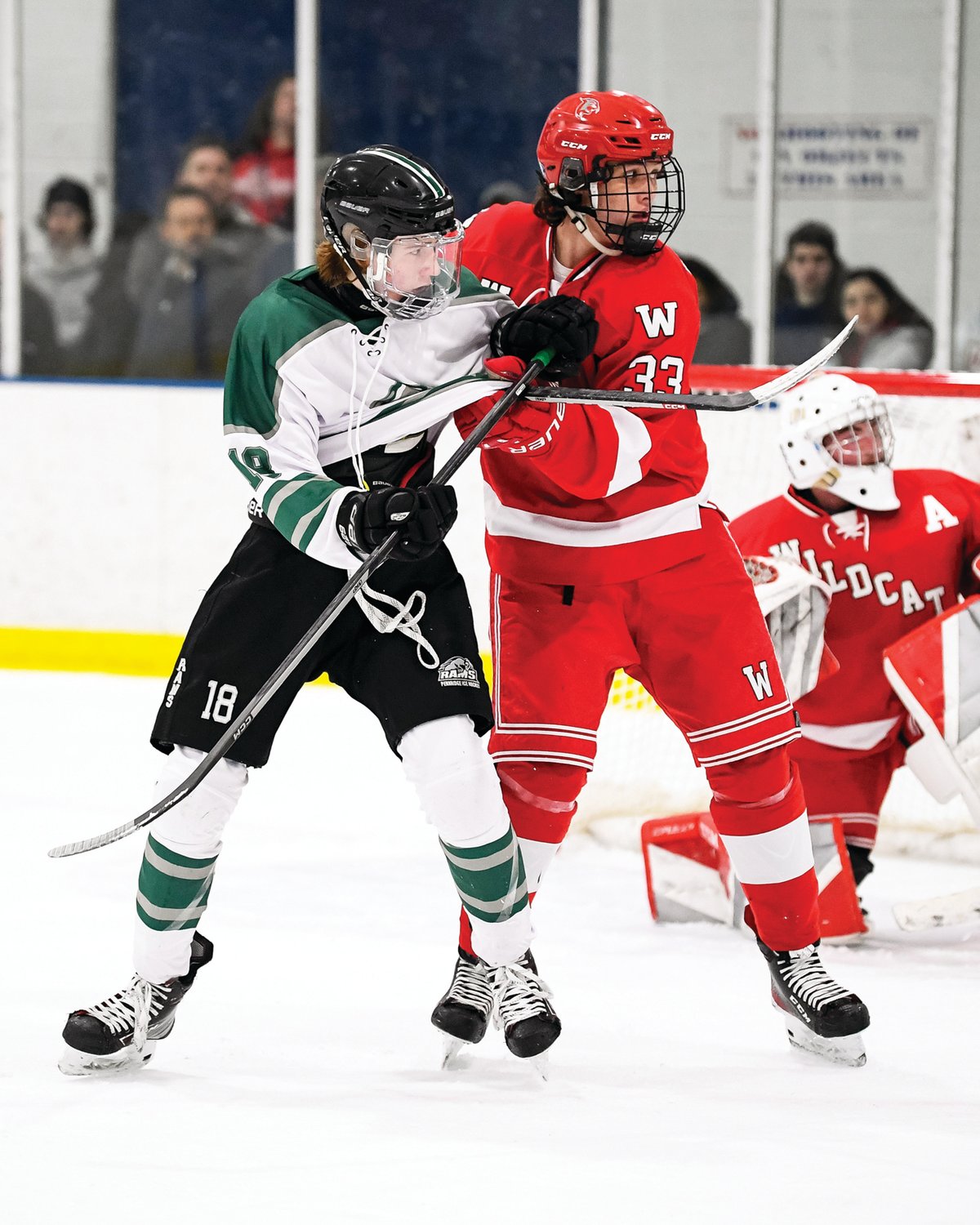 Pennridge’s Andrew Lizak gets his jersey pulled by Owen J. Roberts’ Joe Bacalao as they battle in front of the net.