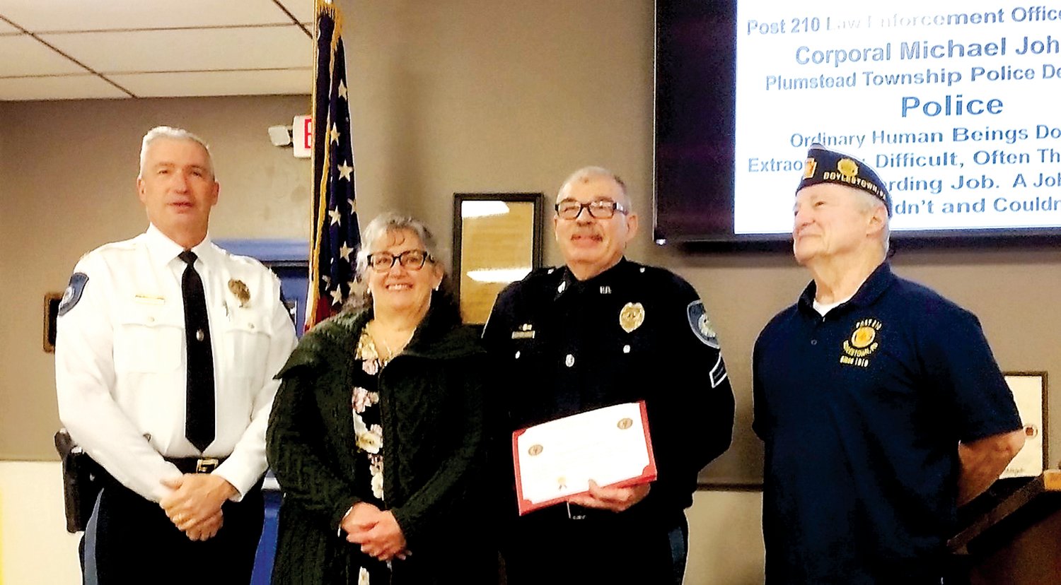 From left are: Chief David Mettin, Plumstead Police Department; Roseanne Johnson, wife of Cpl. Michael Johnson; Cpl. Michael Johnson, Plumstead Police Department; and American Legion Post 210 Commander Pete Scott.