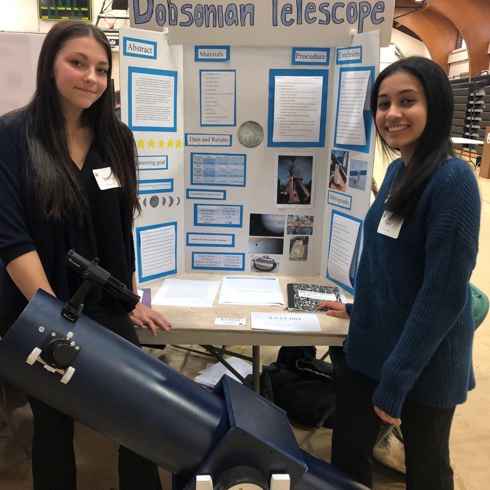 Sydney Groves, 11th grade, and Arya Haridas, 10th grade at Central Bucks East High School, display their hand-built Dobsonian Telescope. They made it from plumbing pipe — a reliable tool to analyze objects in our galaxy.