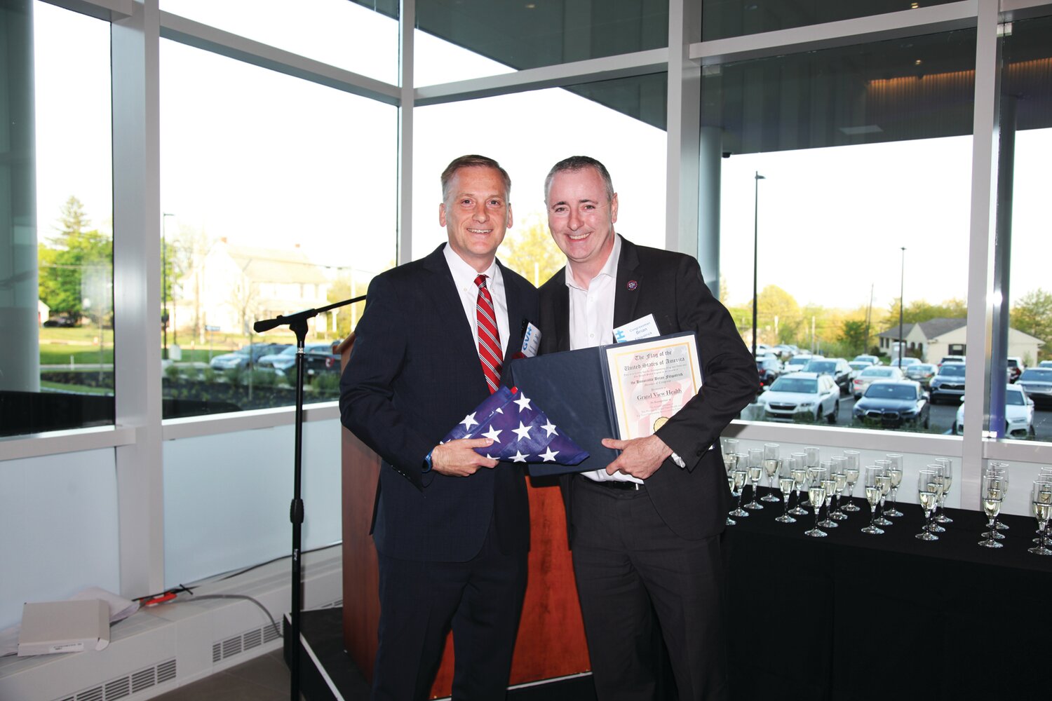 U.S. Rep. Brian Fitzpatrick, right, presents a flag flown over the Capitol to Grand View Health President and Chief Executive Officer Douglas Hughes.