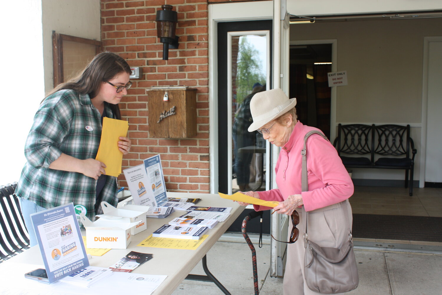 Doylestown Township resident Jean Rutherford, 100, right, looks over a sample ballot outside the Doylestown Township 5 polling place at the Doylestown Senior Center on Tuesday May 16 before voting in the 2023 Pennsylvania Primary Election.
