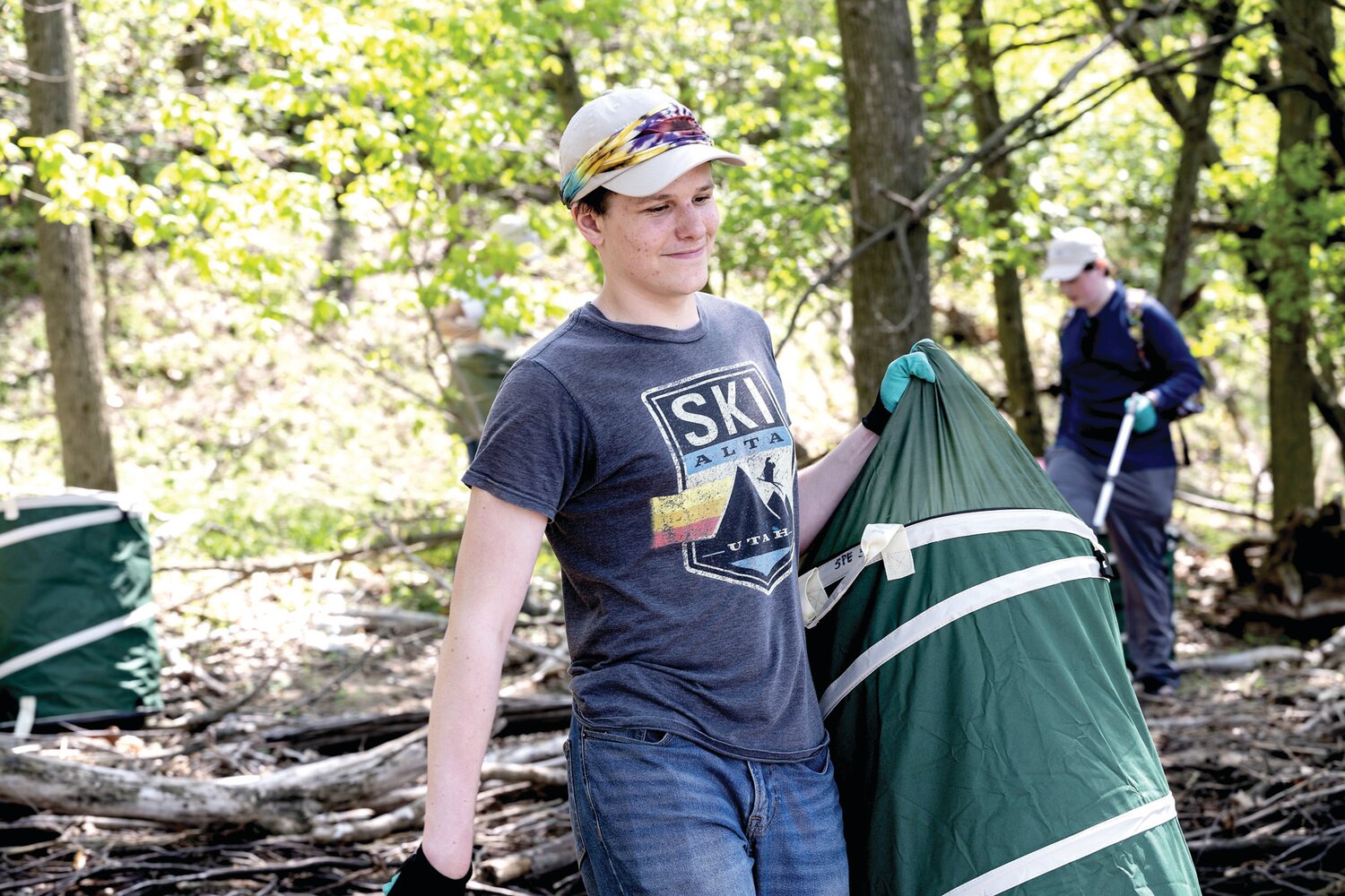 A student volunteer from the Bucks Learning Cooperative transports a bin of plastic waste on Burlington Island. Spearhead Project Earth plans to train 300 volunteers for environmental cleanup efforts by the end of 2023.