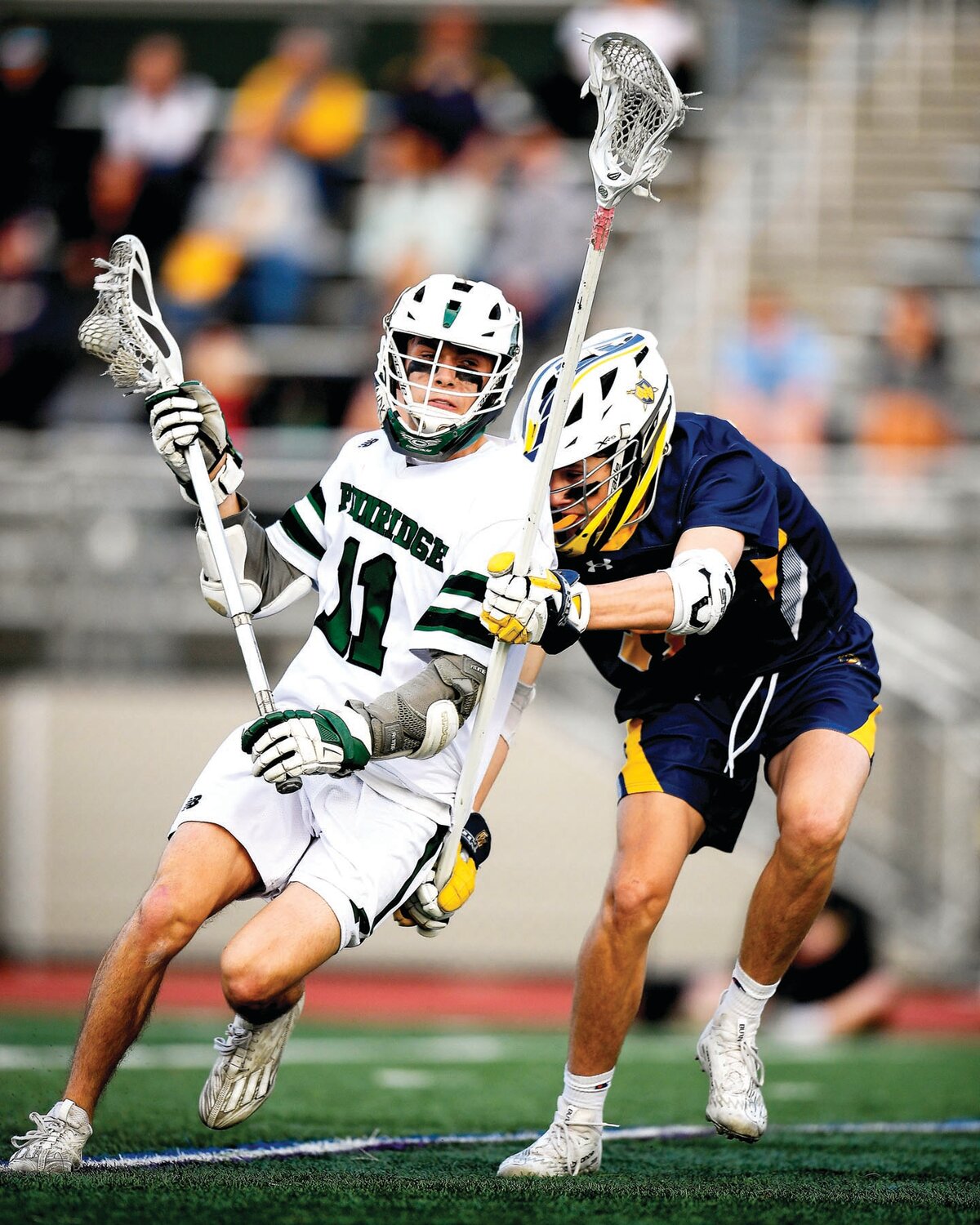 Pennridge’s Matt Kriney gets checked from behind by Wissahickon’s Dan Hussa while attempting to get off a shot.