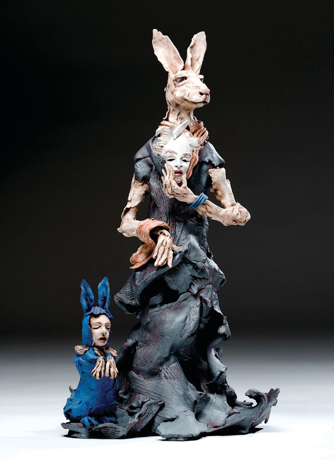 “Behind the Mask” is a 2021 ceramic with slip, underglaze, oxide, stain, by Michael High.