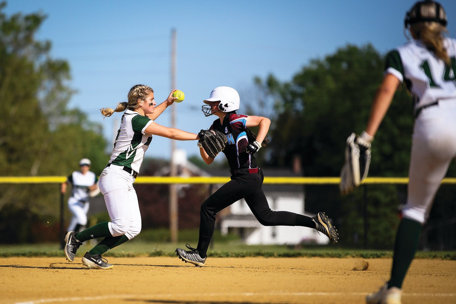 Dock Mennonite’s Trinity Landis makes a throw while Faith Christian’s Sammy Snyder advances during the top of the seventh inning.