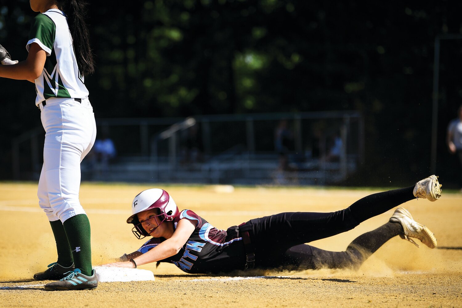 Faith Christian’s Kamryn Pepkowski reaches for the bag ahead of the throw in the third inning.