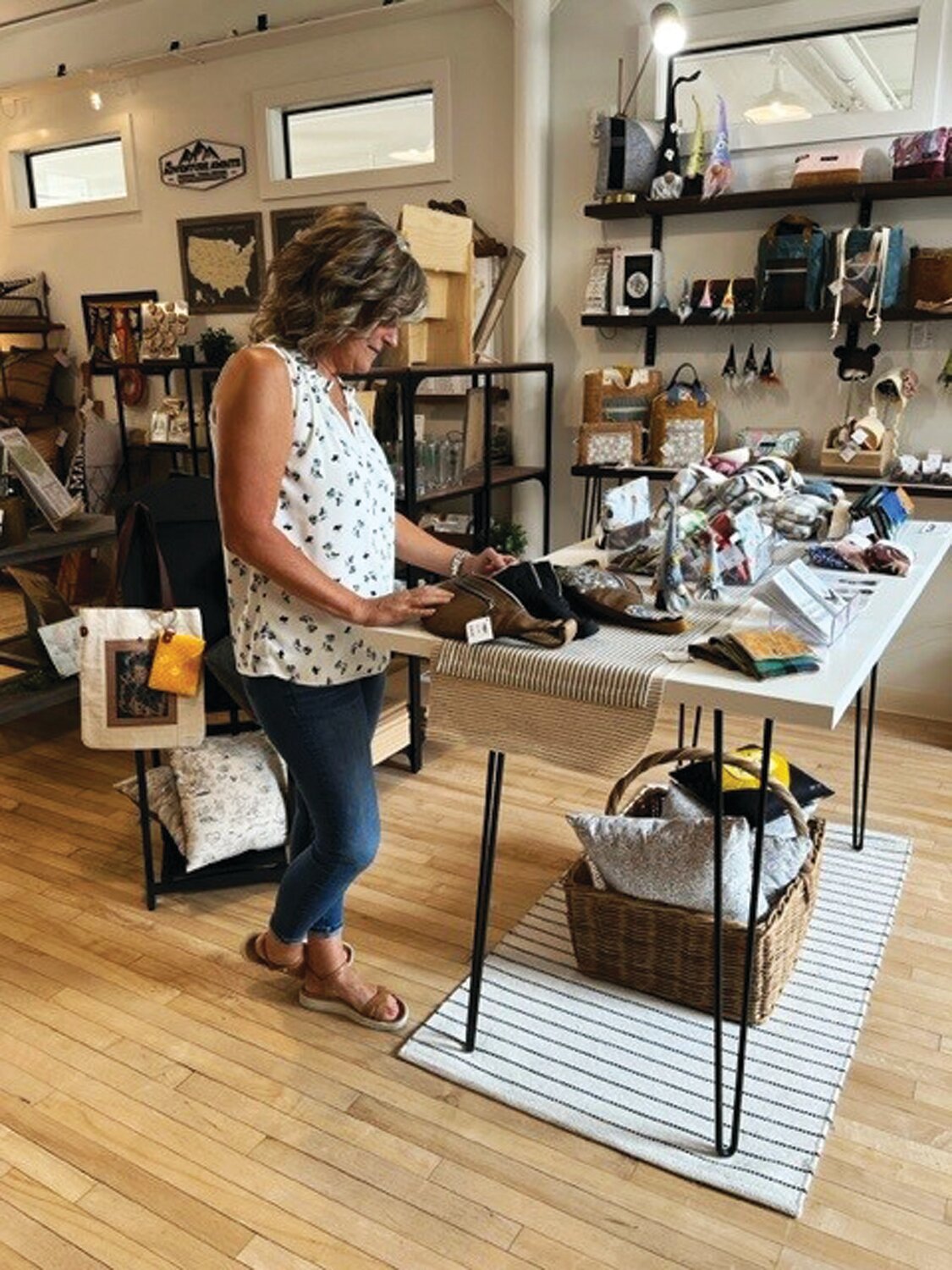 Corinna Garis, marketing director for Dublin Town Center, looks over some handmade items at Makers, a craft boutique at The Square.