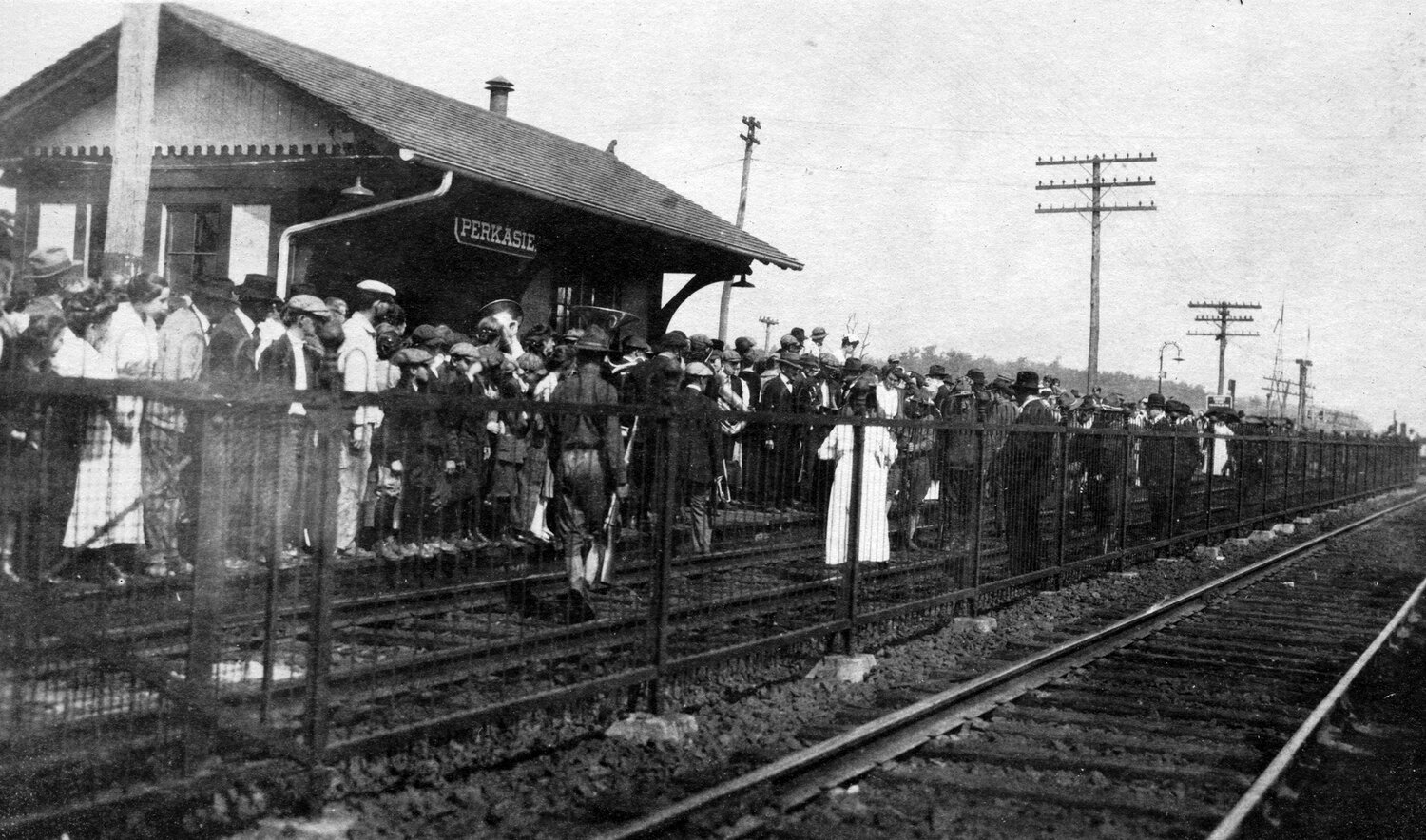 Riders await the arrival of a train in 1918 at the Perkasie station.