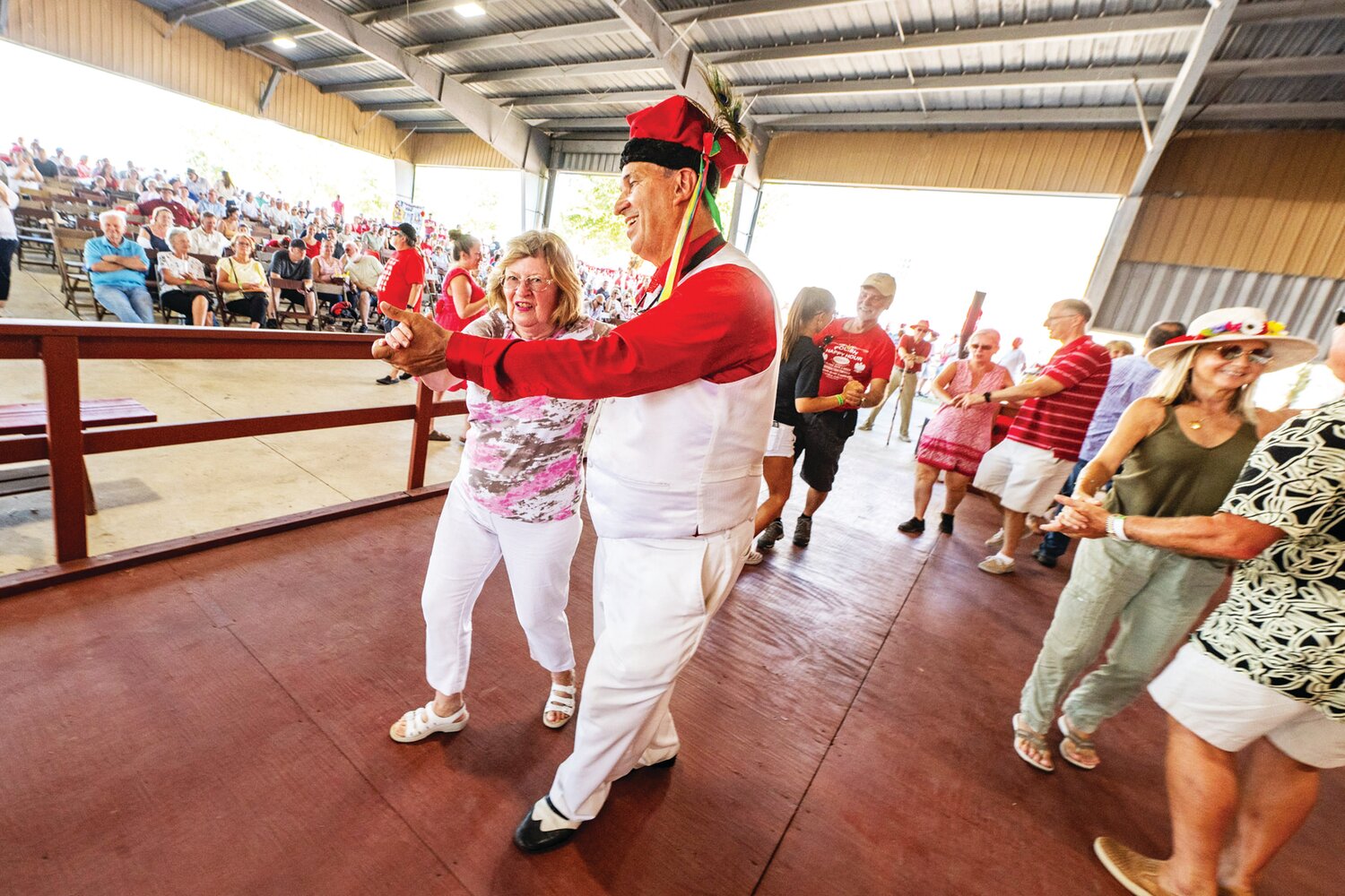 Gerry Kudach joins audience members as they dance to live music played by the John Stevens Band during the 57th annual Polish American Family Festival & Country Fair.