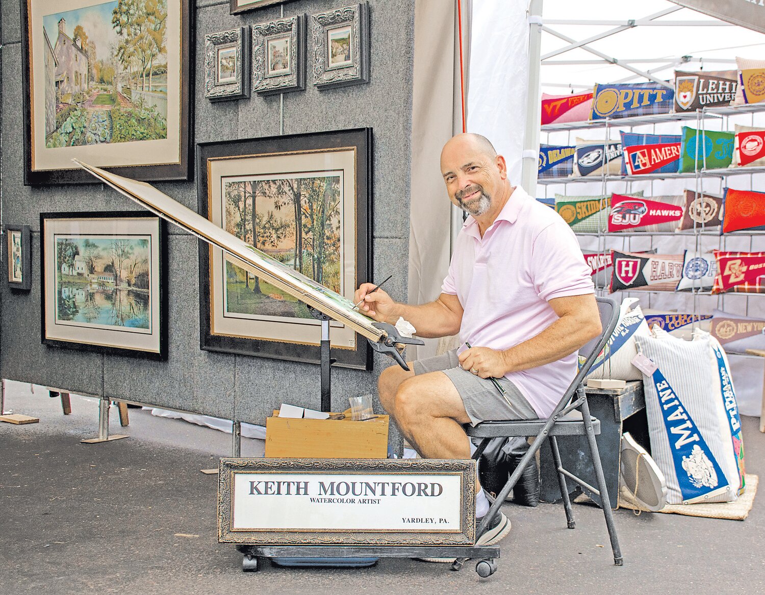 Watercolor artist Keith Mountford paints during the arts festival.