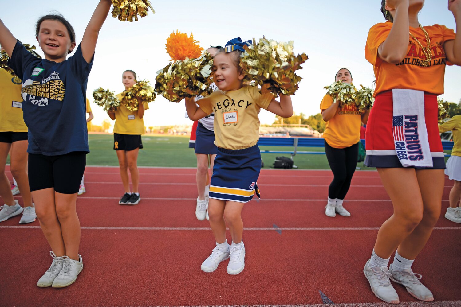 Five-year-old cheerleader Juliette Sailor of Our lady of Mount Carmel during pregame activities with the Central Bucks East cheerleaders.